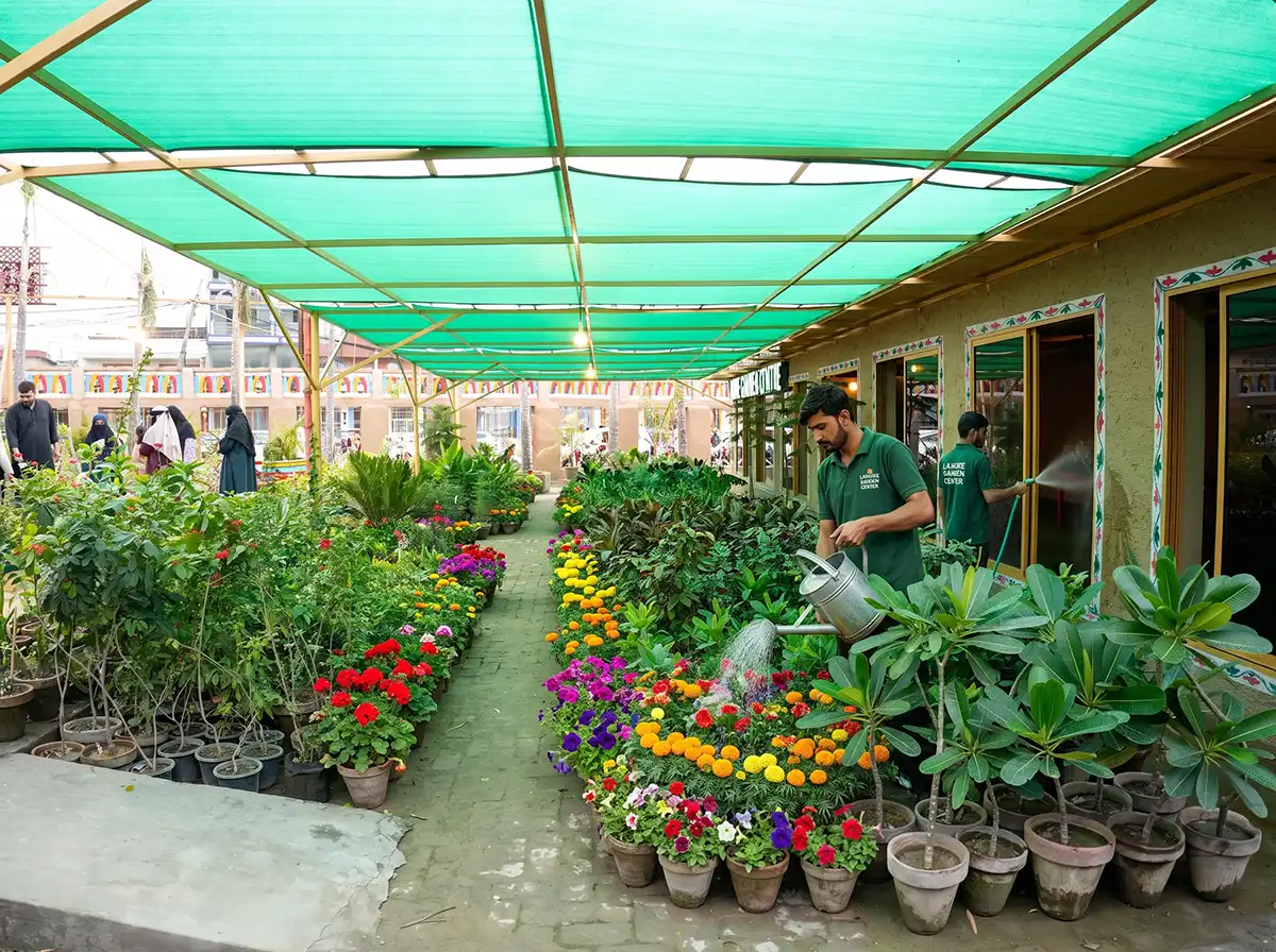 Shelves stocked with gardening tools, soil bags, and pots