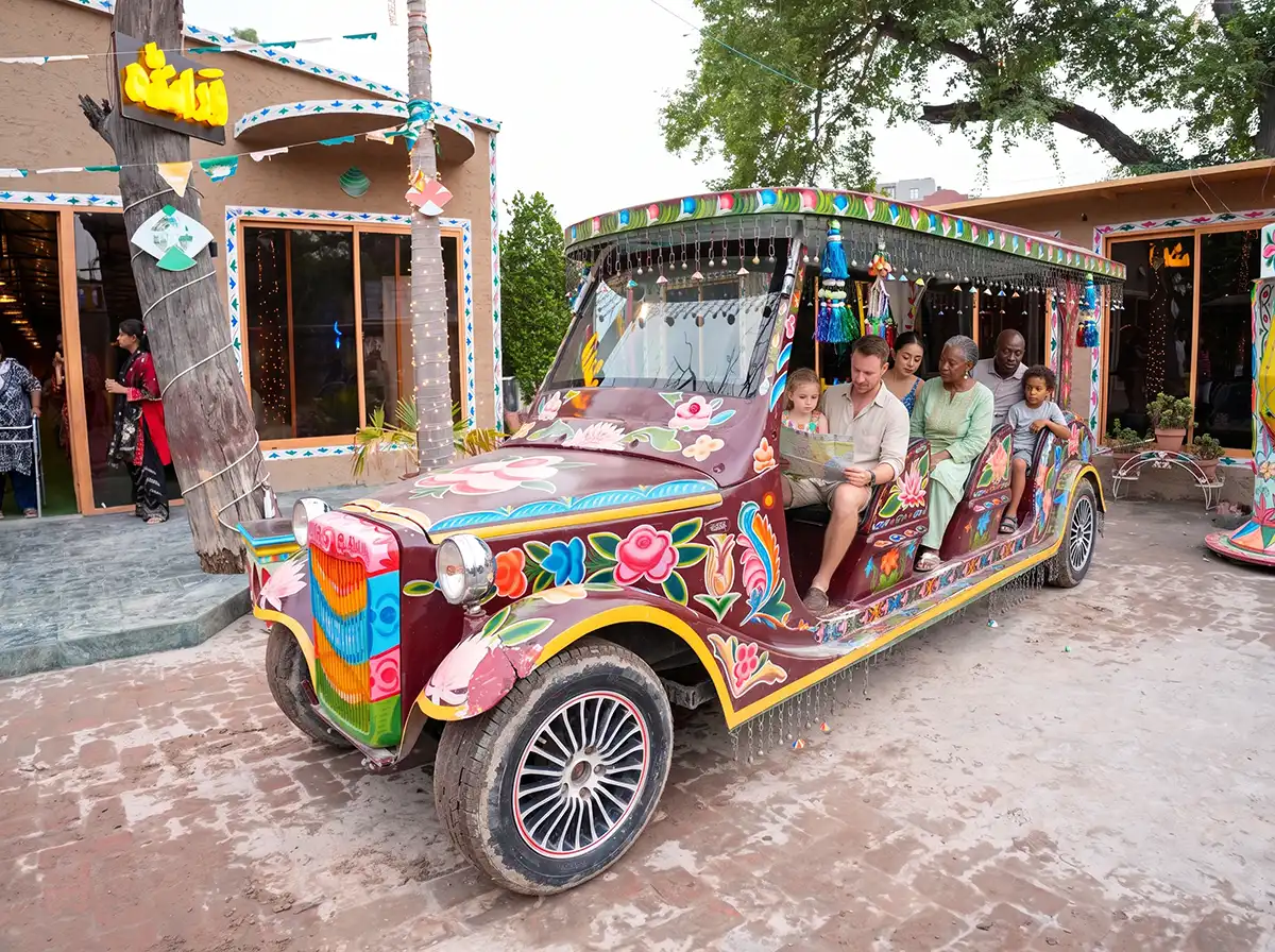 Guests relaxing inside the colorful truck art golf cart reviewing their map