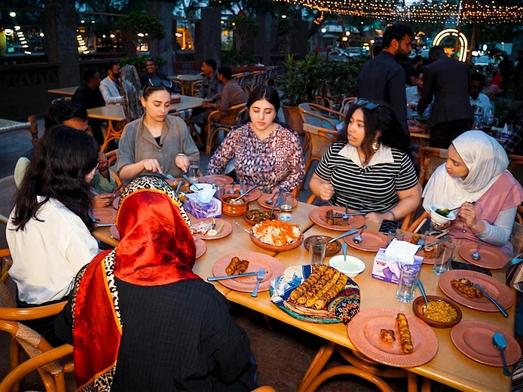 Family and friends sharing a meal together at Desi Dhaba, Lahore Organic Village