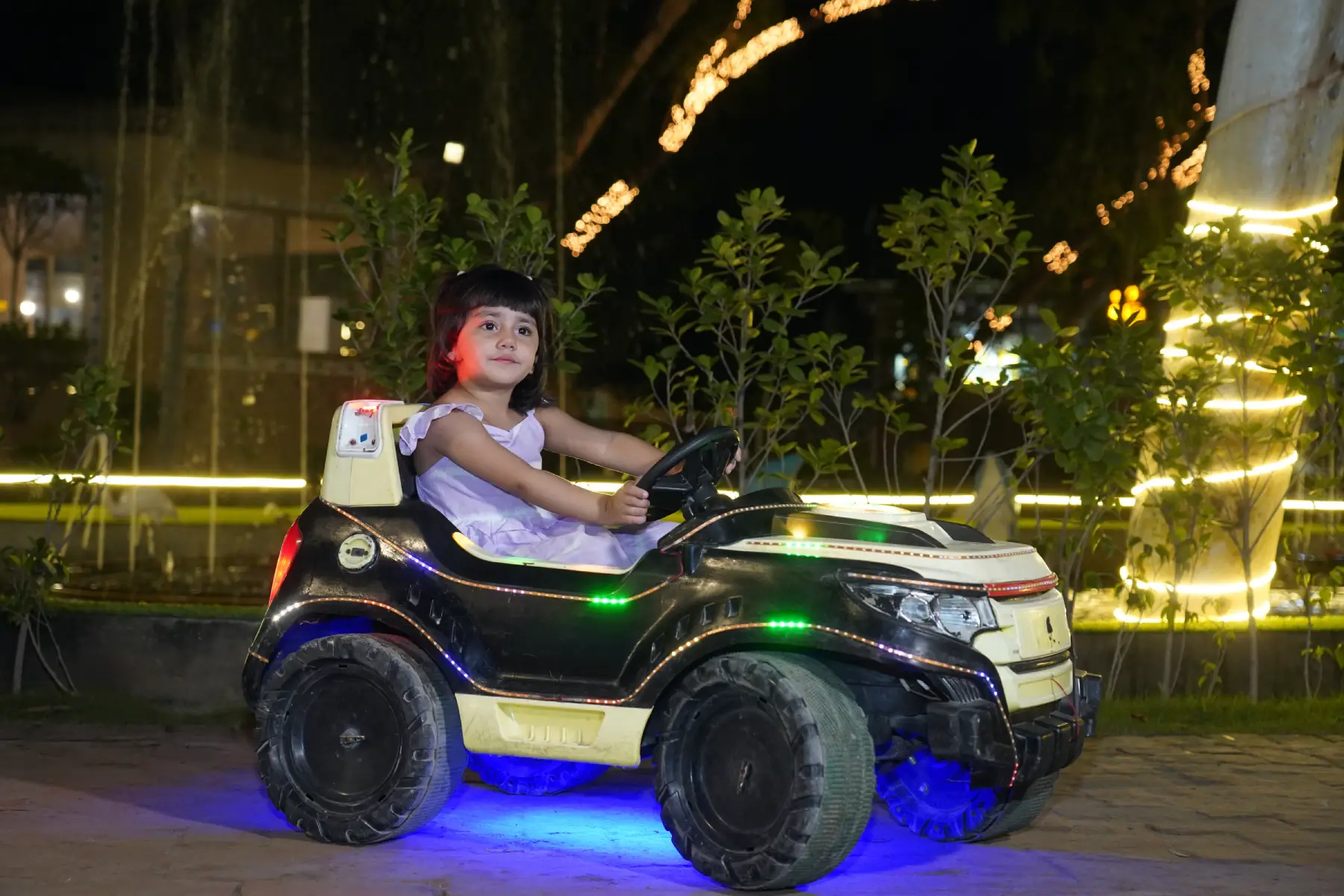 Children enjoying rides, slides, and train tracks in outdoor kids park