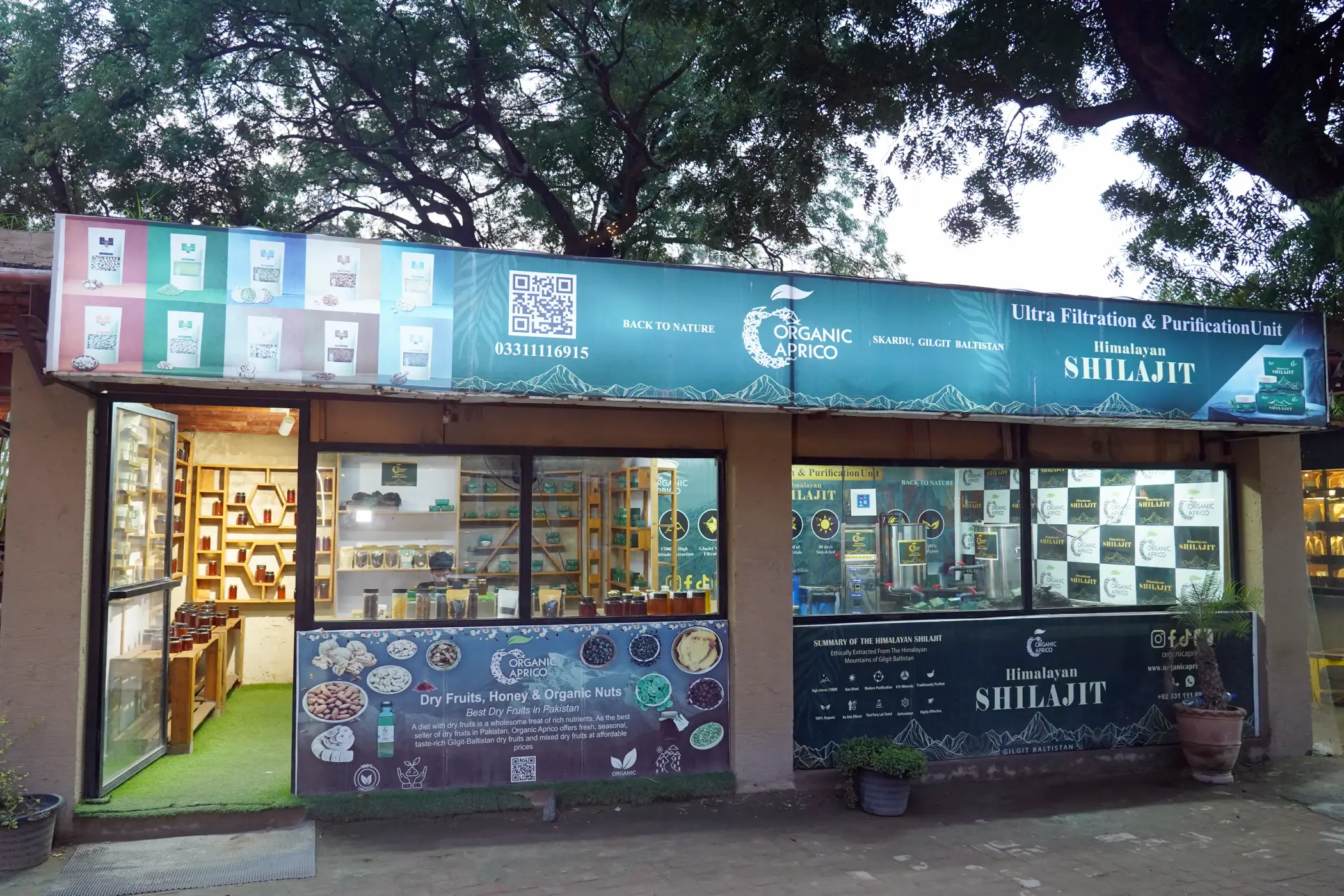 Exterior view of Organic Aprico retail store offering pure honey, dried fruits, and Shilajit at Lahore Organic Village.