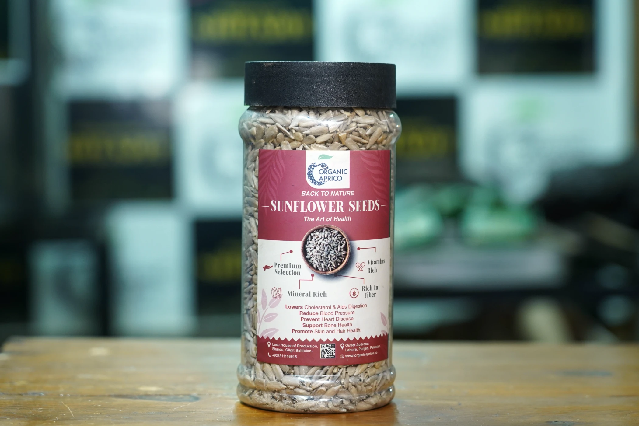 Premium raw sunflower seeds jar by Organic Aprico displayed at Lahore Organic Village outlet for healthy snacking nutrition.